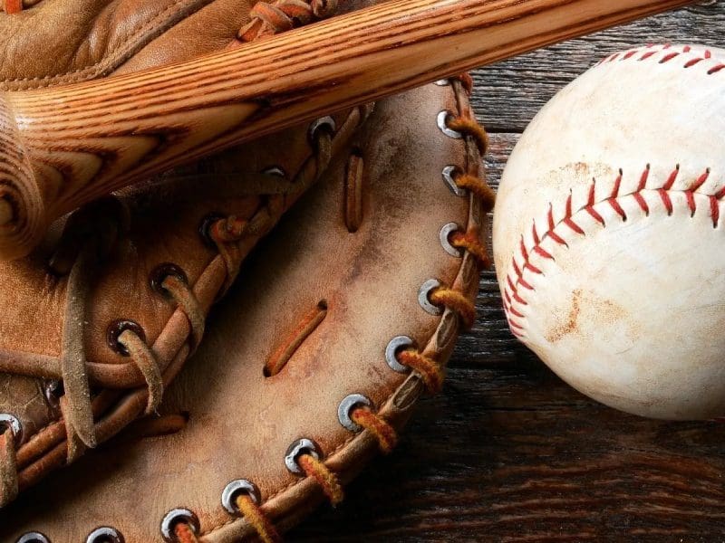 A baseball glove and ball on top of a table.