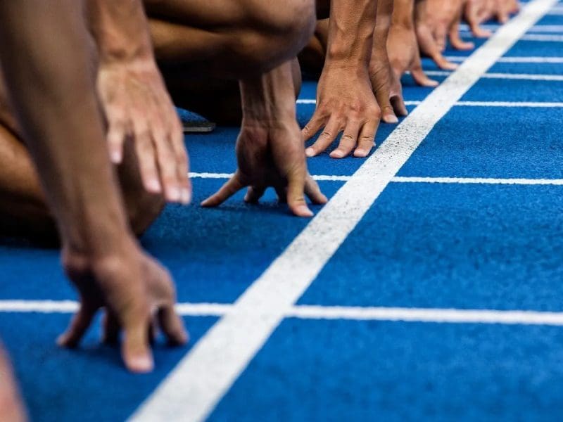 A group of people standing on top of a track.